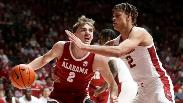 Alabama Crimson Tide forward Grant Nelson (2) drives against Arkansas Razorbacks forward Trevon Brazile (2) at Coleman Coliseum.